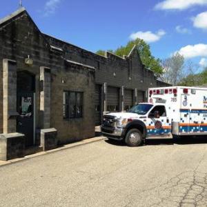 Exterior of Greentree station with an ambulance parked at an angle outside the front door